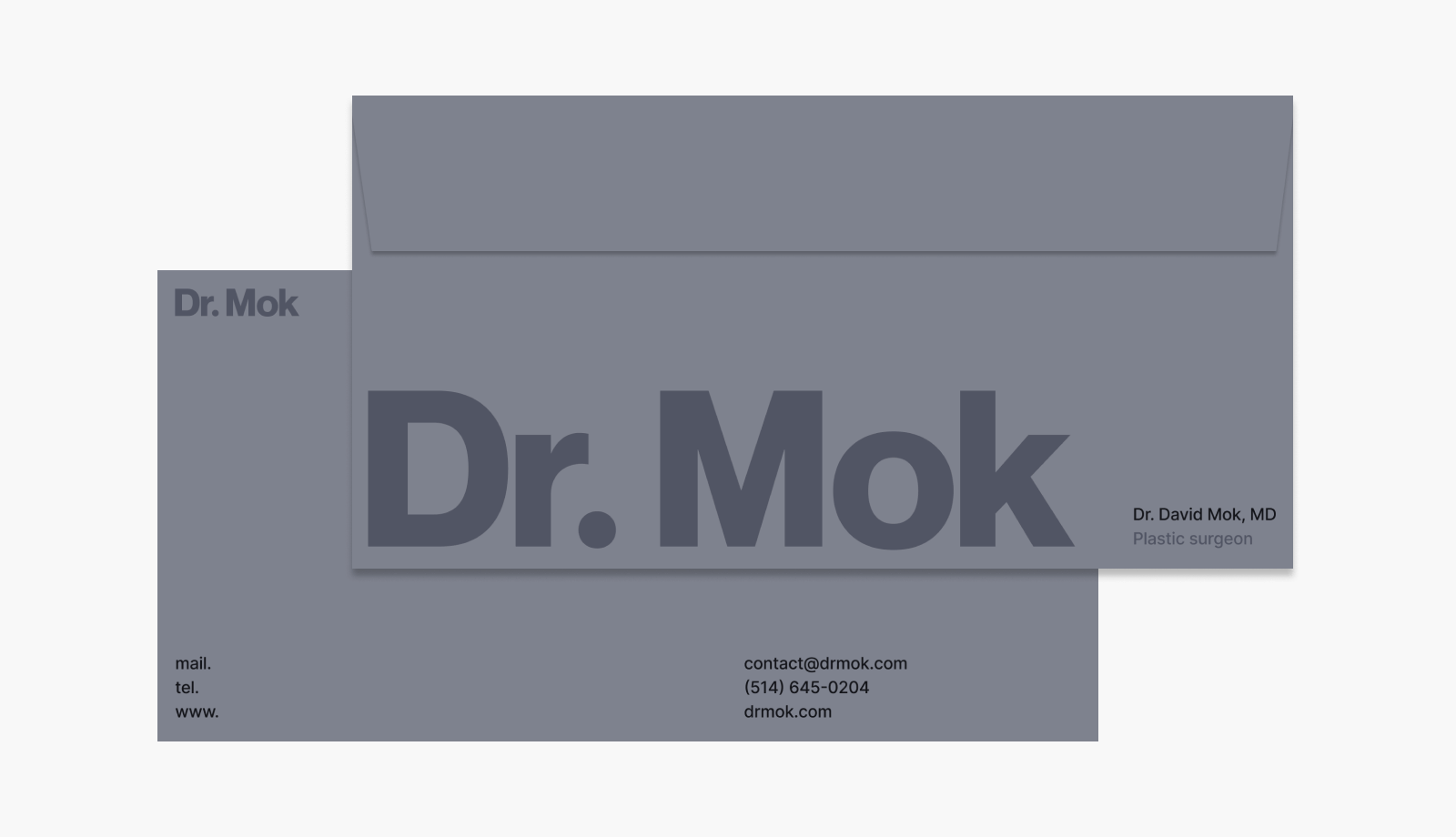 A grey envelope and card with the Dr. Mok logotype set large